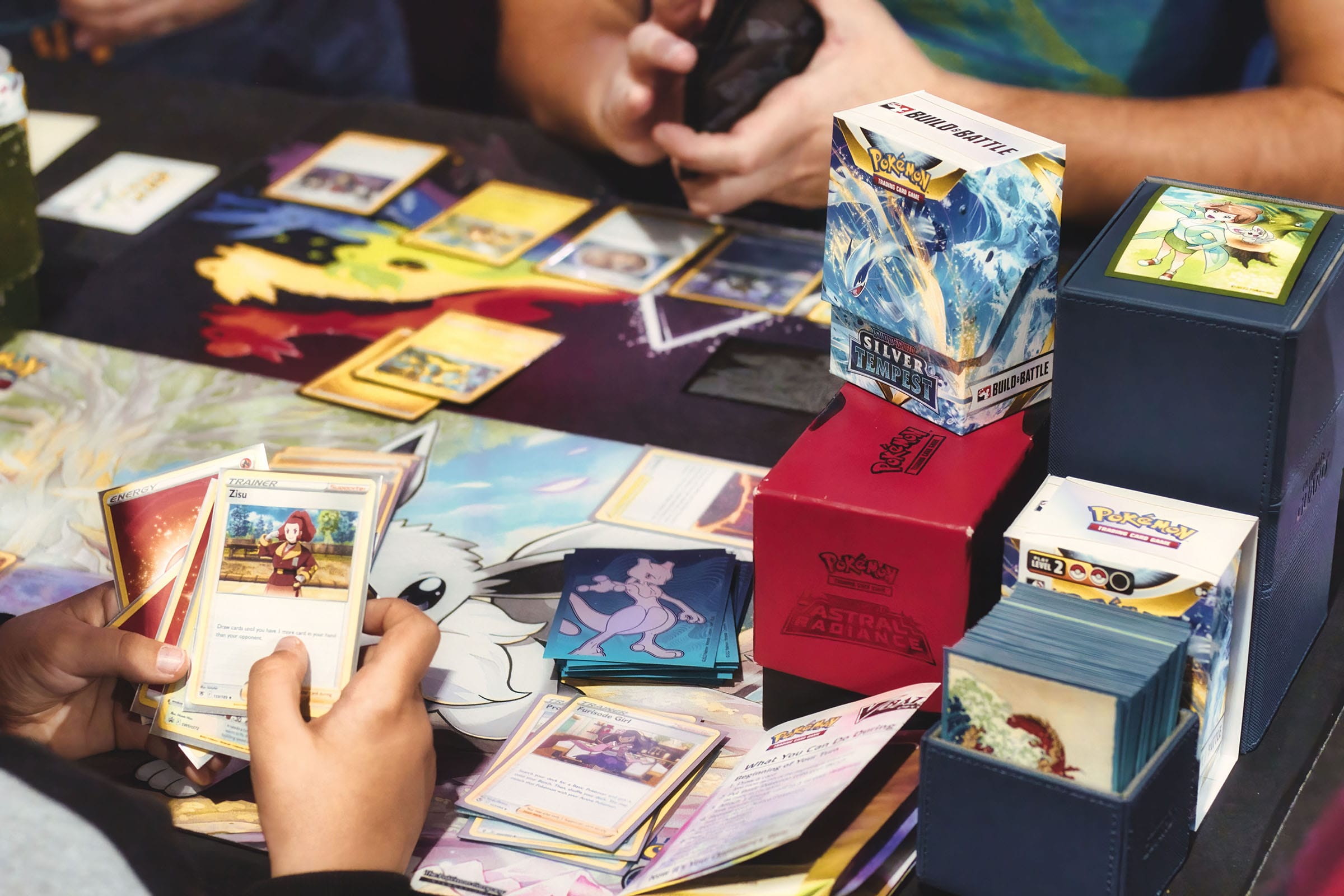 Playing a trading card game with Pokémon cards.
